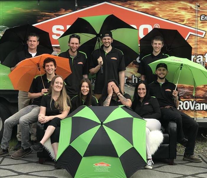 Staff group photo with umbrellas